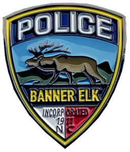 Shield Shaped Golf Ball Marker With an Elk Engraved Image and the Words Police, Banner Elk Lodge.