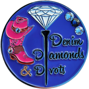 Ball Marker with a Blue Background. Engraved with an image of a diamond setting on a tee, with a cowboy boot and Swarovski crystals. With the Words Denim, Diamonds and Divots.