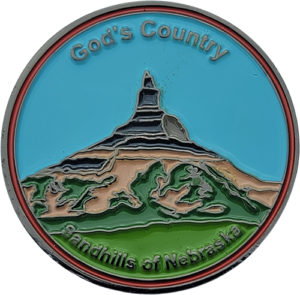 Ball Marker with engraved image of a mountain with the words Gods Country printed on the marker